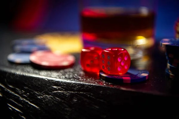 Close-up of transparent dice cage with three dice ready to roll